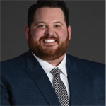 A headshot of Brett Poulos
